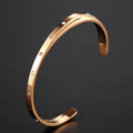 Women's stainless steel open-ended bracelet with inlaid zircon stones in gold colour.