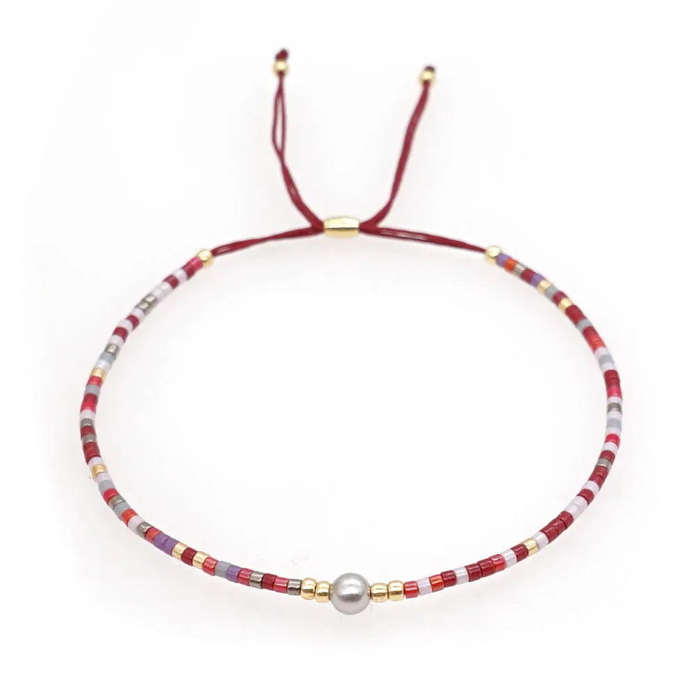 Handmade colourful beaded bracelet with geometric glass and glaze beads in bohemian style