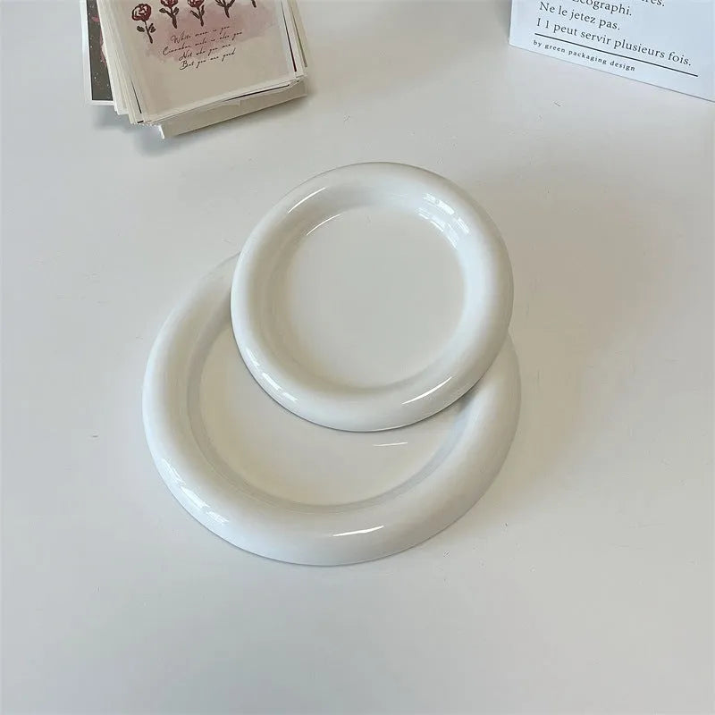 White porcelain plate with doodle design, shown in round and bear shapes, small and large sizes.