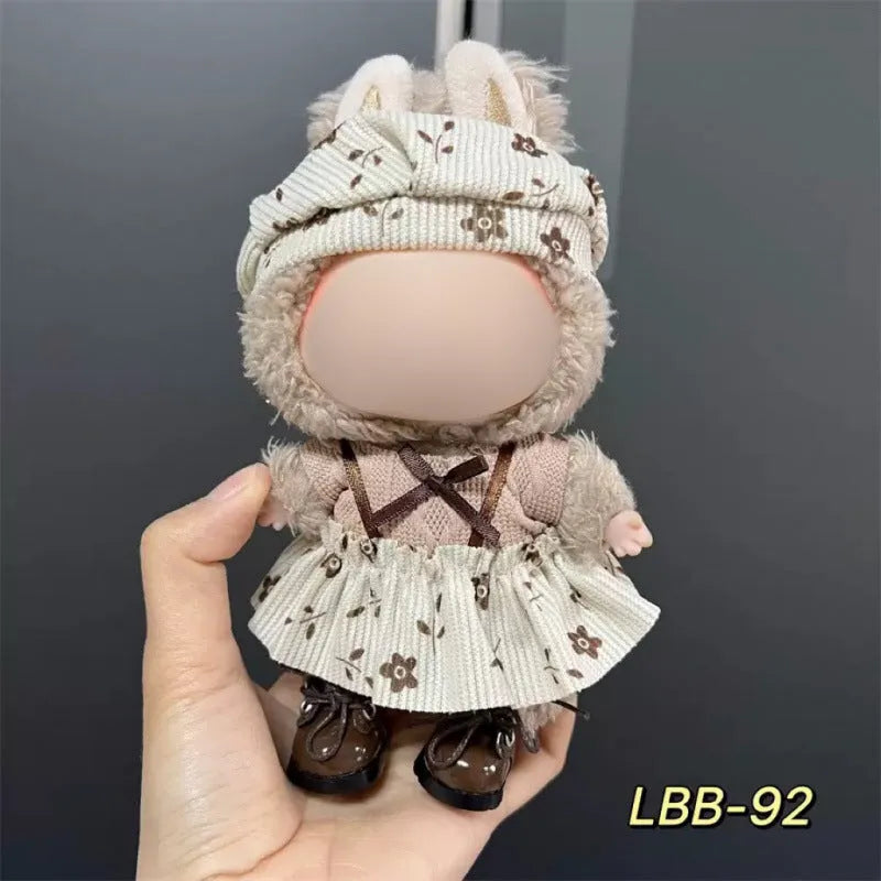 Plastic clothing outfit for a 17cm tall vinyl figure or doll on a display stand.
