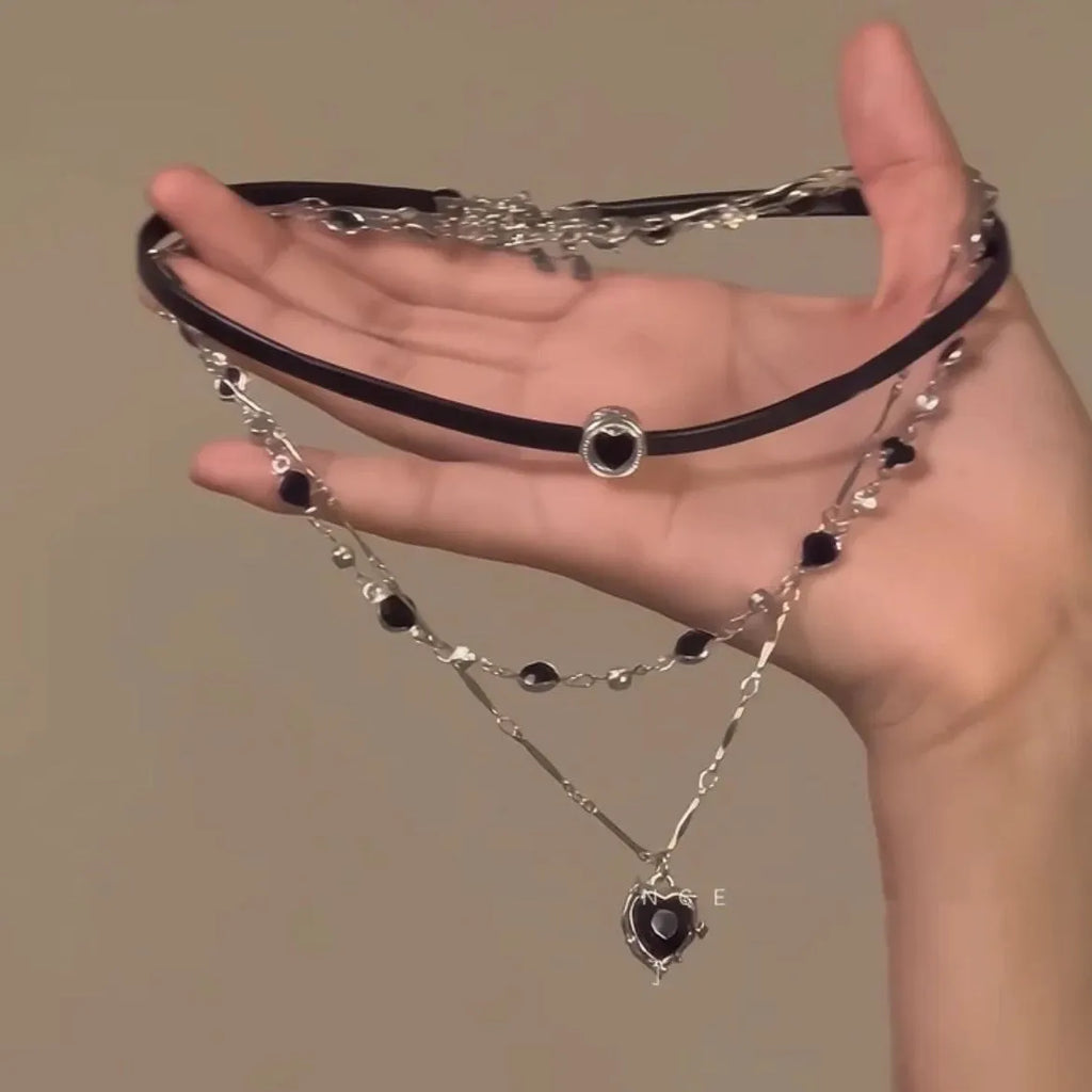 Women's multi-layer heart necklace set with alloy pendant, artificial crystal, and leather accents on an adjustable clavicle chain.