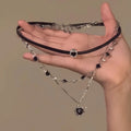 Women's multi-layer heart necklace set with alloy pendant, artificial crystal, and leather accents on an adjustable clavicle chain.