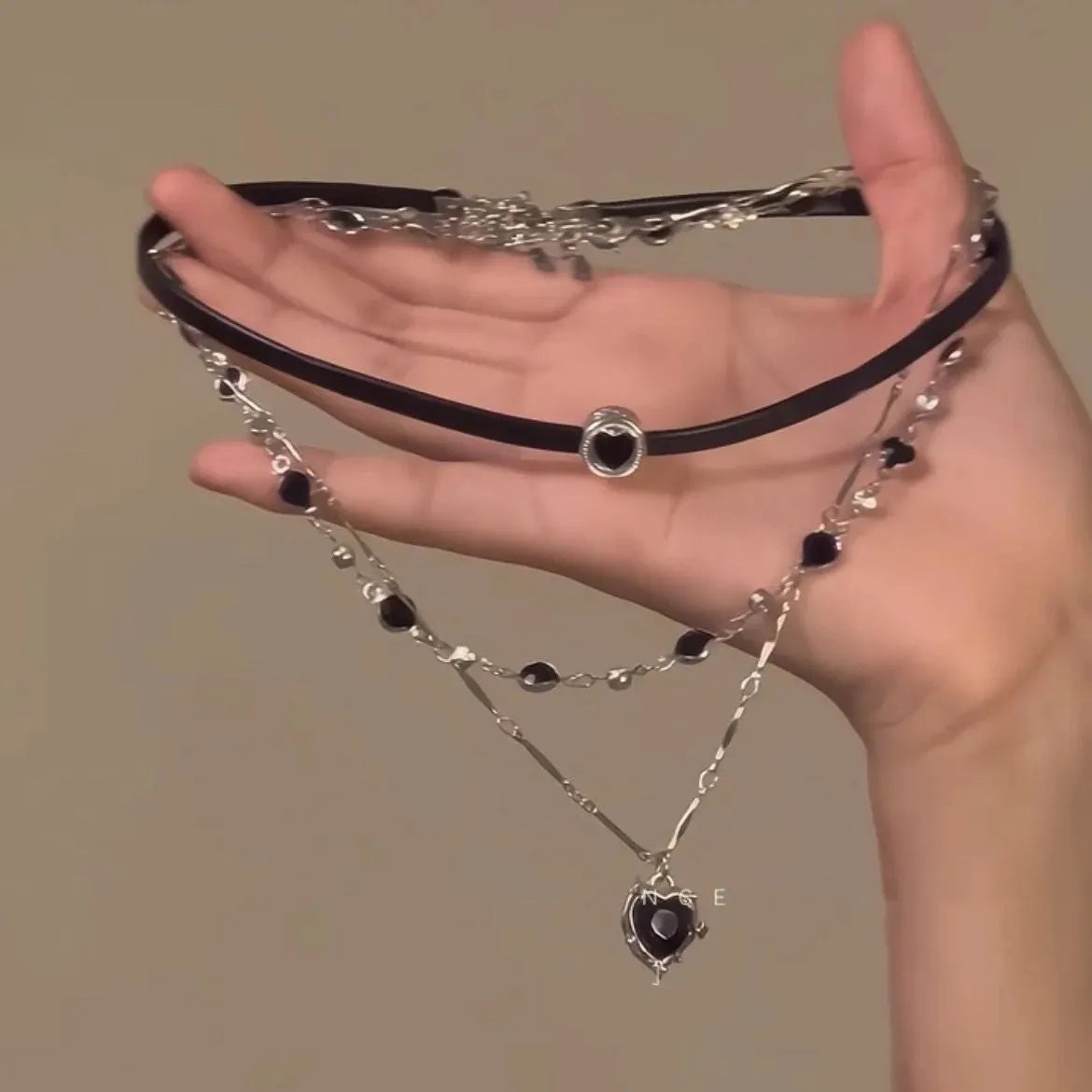 Women's multi-layer heart necklace set with alloy pendant, artificial crystal, and leather accents on an adjustable clavicle chain.