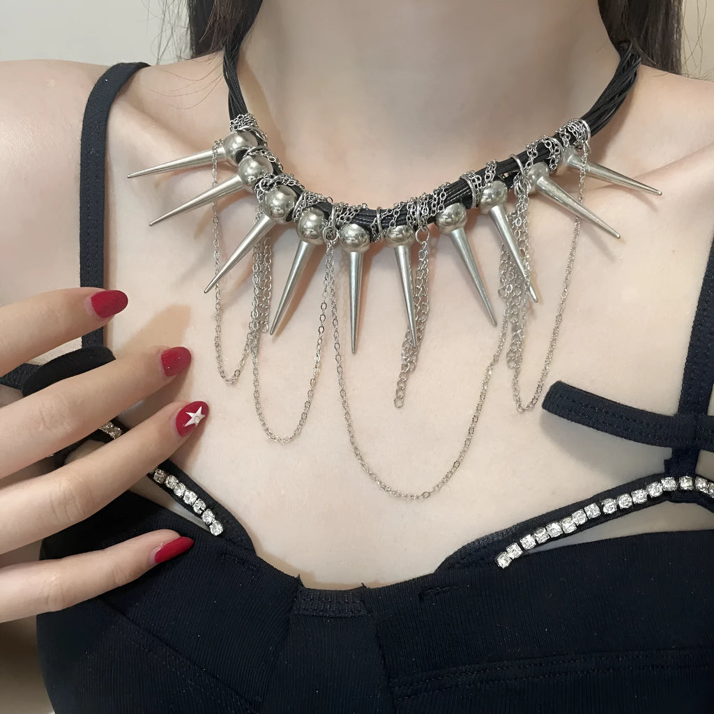Leather necklace with electroplated round beads, winding design, tassel, and point rivet details.