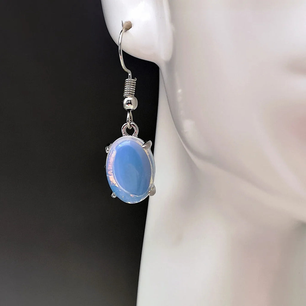 A pair of opal drop earrings with a retro moonstone design and electroplated alloy finish in a moonlight white colour.