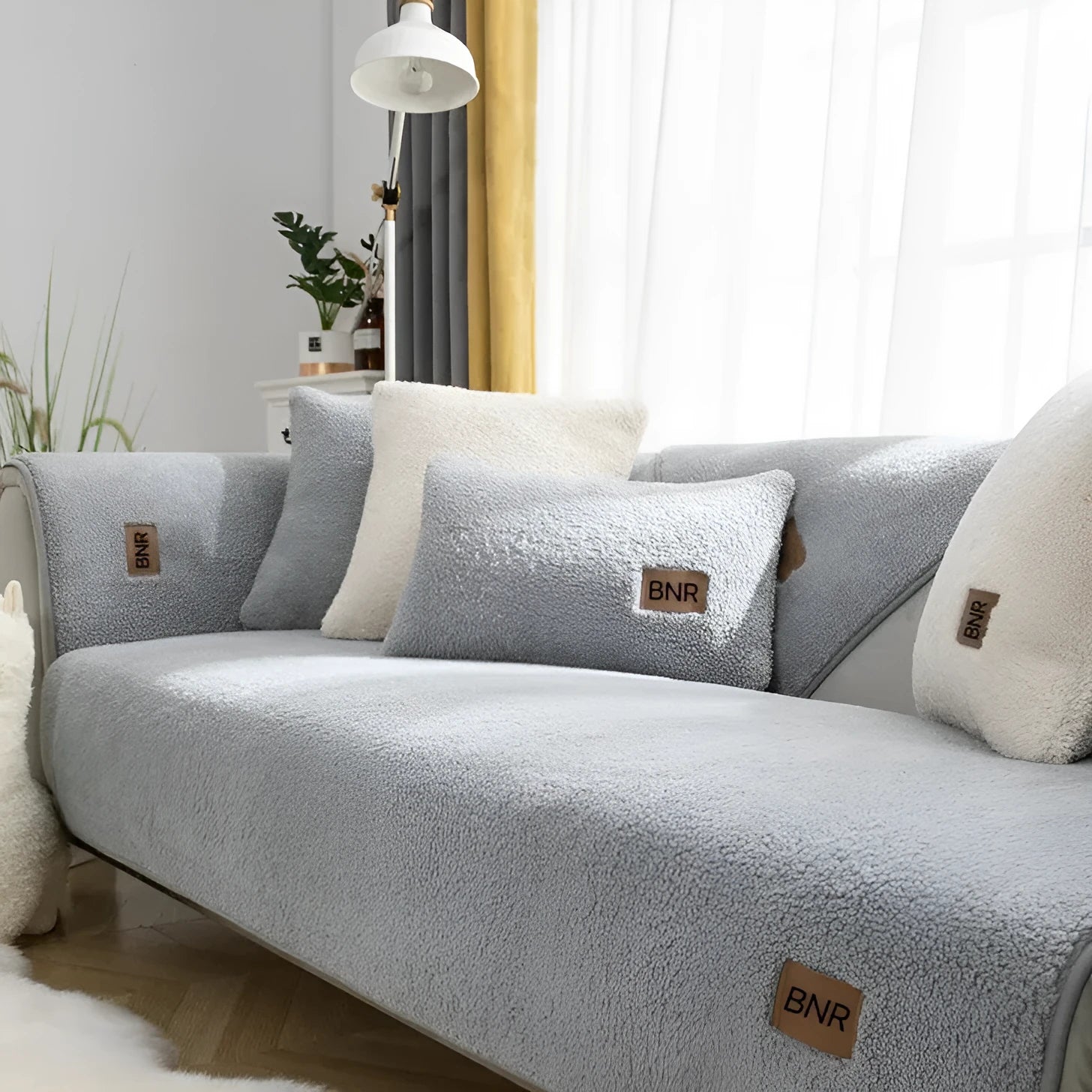 Lambswool sofa slipcover in solid blue colour laid flat, showing its texture and simple design.