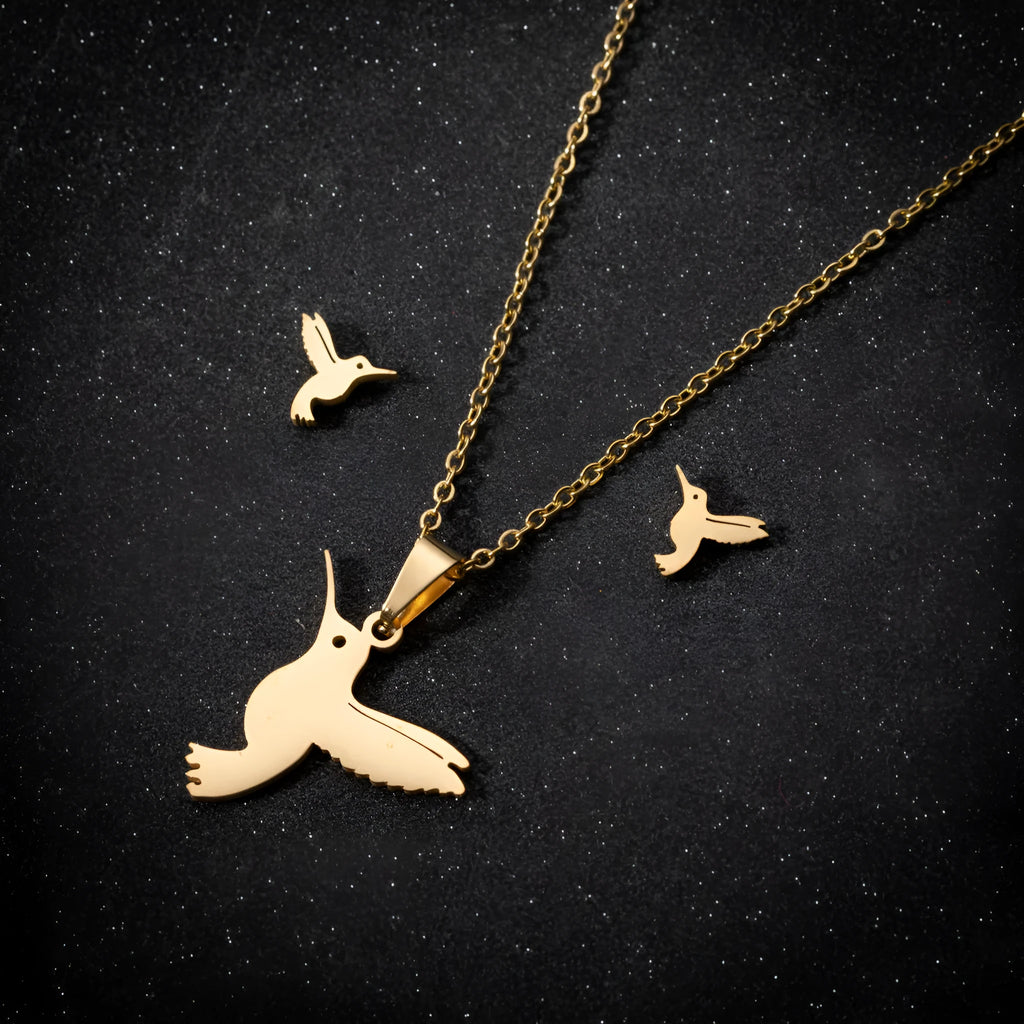 Cute little animal stainless steel jewellery set with bird motif necklace and earrings in gold colour on a white background