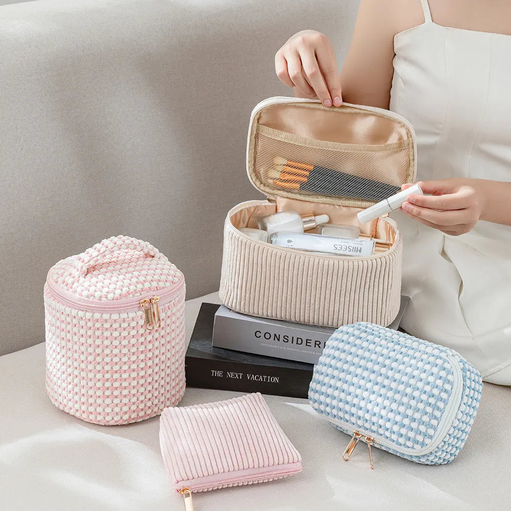 Four cube-shaped flannelette makeup bags in a set, shown in a blue with dots pattern.