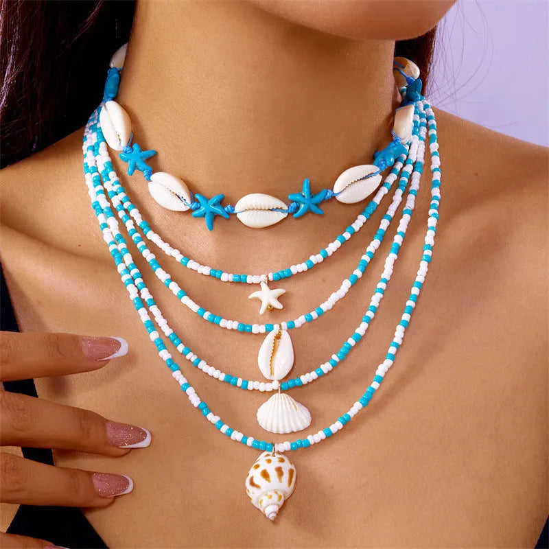 Five-piece women's necklace set with starfish shell and conch bead designs on adjustable chain