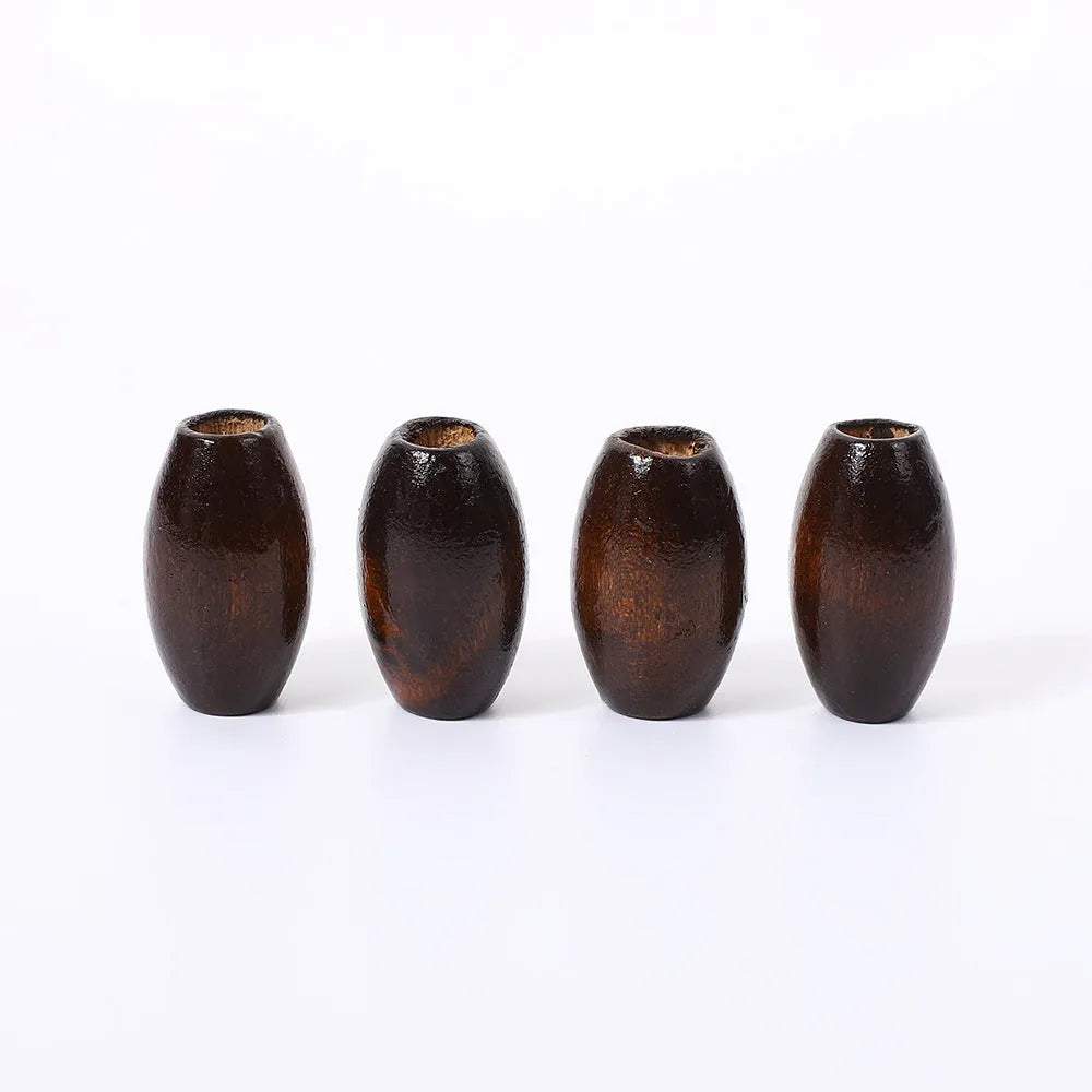 Dark coffee coloured oval wooden bead with M-shaped raised design, 25mm size