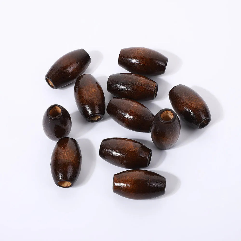 Dark coffee coloured oval wooden bead with M-shaped raised design, 25mm size
