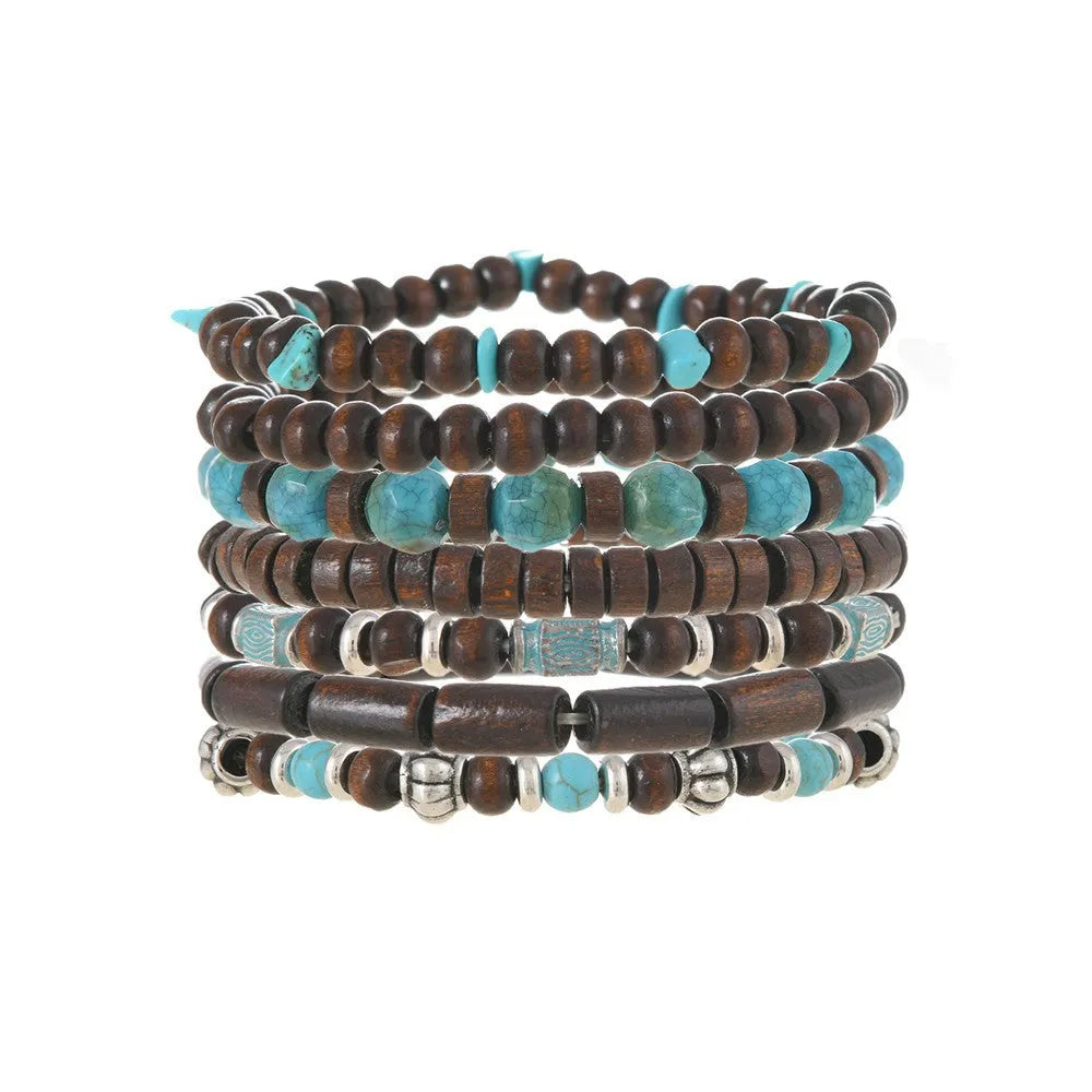 Set of seven multicolour retro bracelets with wooden beads and alloy accents laid flat.