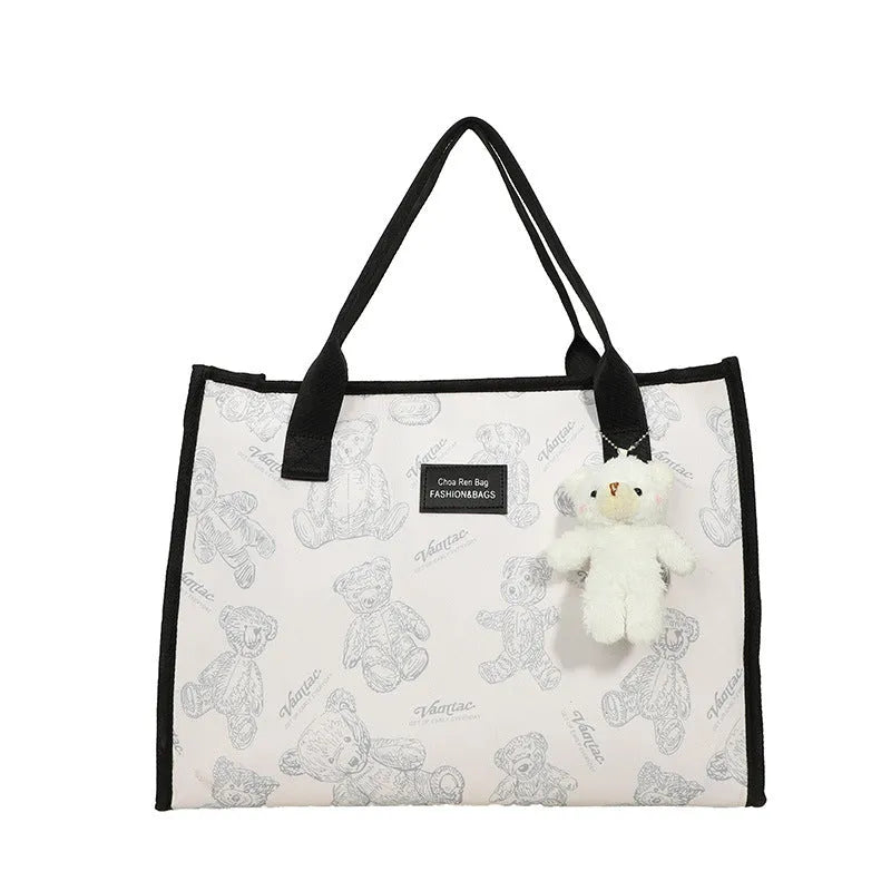 Women's printed canvas tote bag with rhombus pattern showing horizontal square shape and shoulder strap