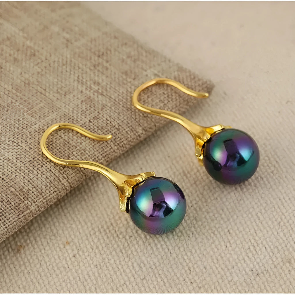 A pair of gold-coloured retro fashion earrings for women with an alloy construction.