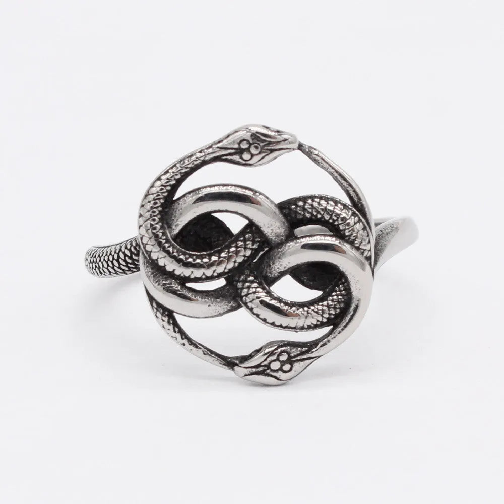 Close-up of a titanium steel double snake ring with a retro design on a hand, showing the intricate intertwined serpent detail.