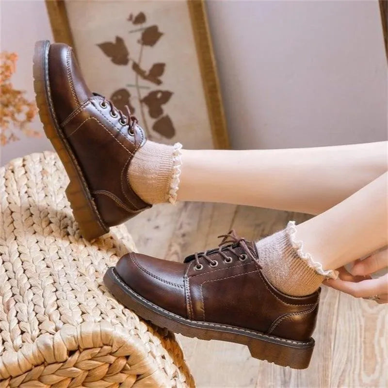 Women's black preppy retro Mary Jane shoes with round toe and front lace-up.