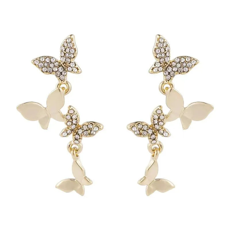 Gold tone butterfly drop earrings with four copper charms on each piece for women