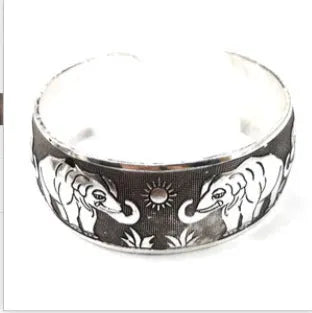 Miao ethnic silver-style bracelet with carved open design in alloy construction