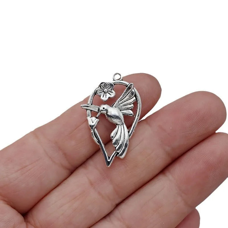 Silver-toned alloy DIY pendant with detailed magpie pattern, shown against a plain background.