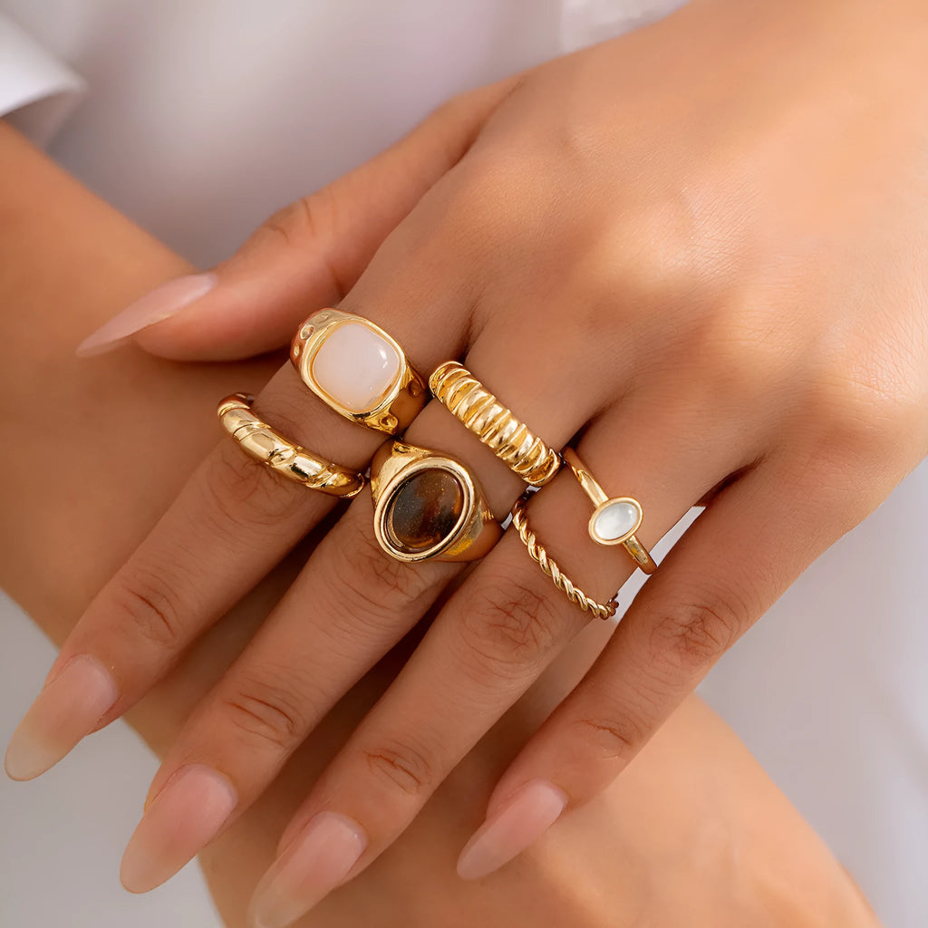 Six irregular geometric alloy rings in light gold electroplated finish arranged as jewellery set