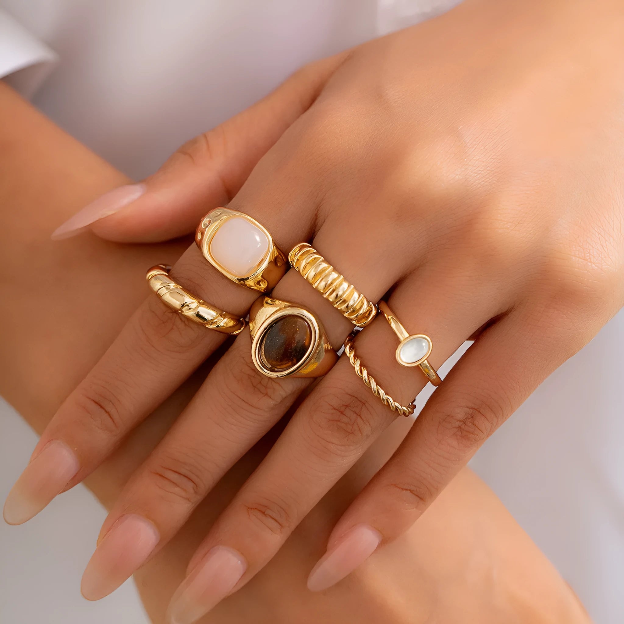 Six irregular geometric alloy rings in light gold electroplated finish arranged as jewellery set
