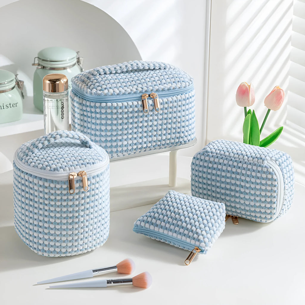 Four-piece set of cube-shaped flannelette makeup bags in a choice of colours.