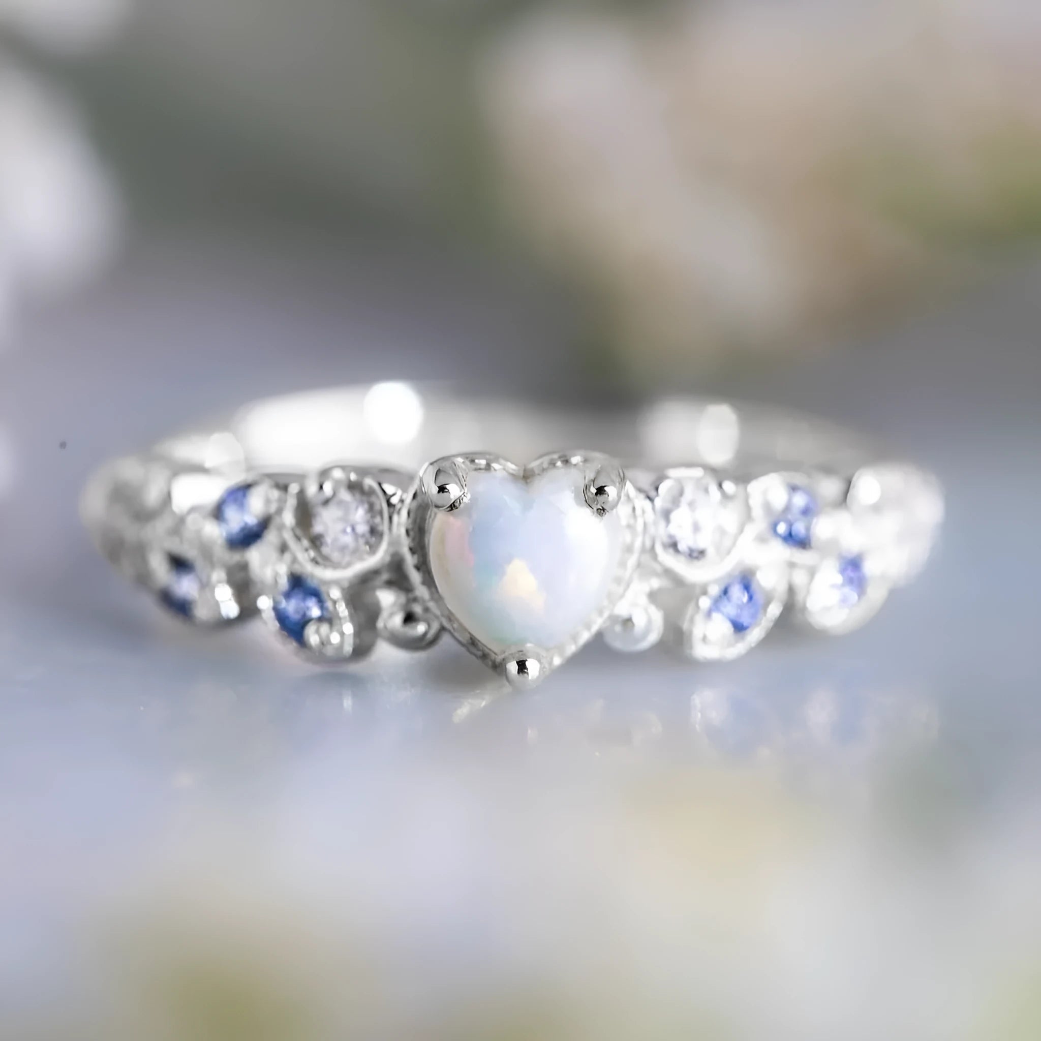 Women's white heart-shaped ring with flower opal ocean pattern detail in peach heart design