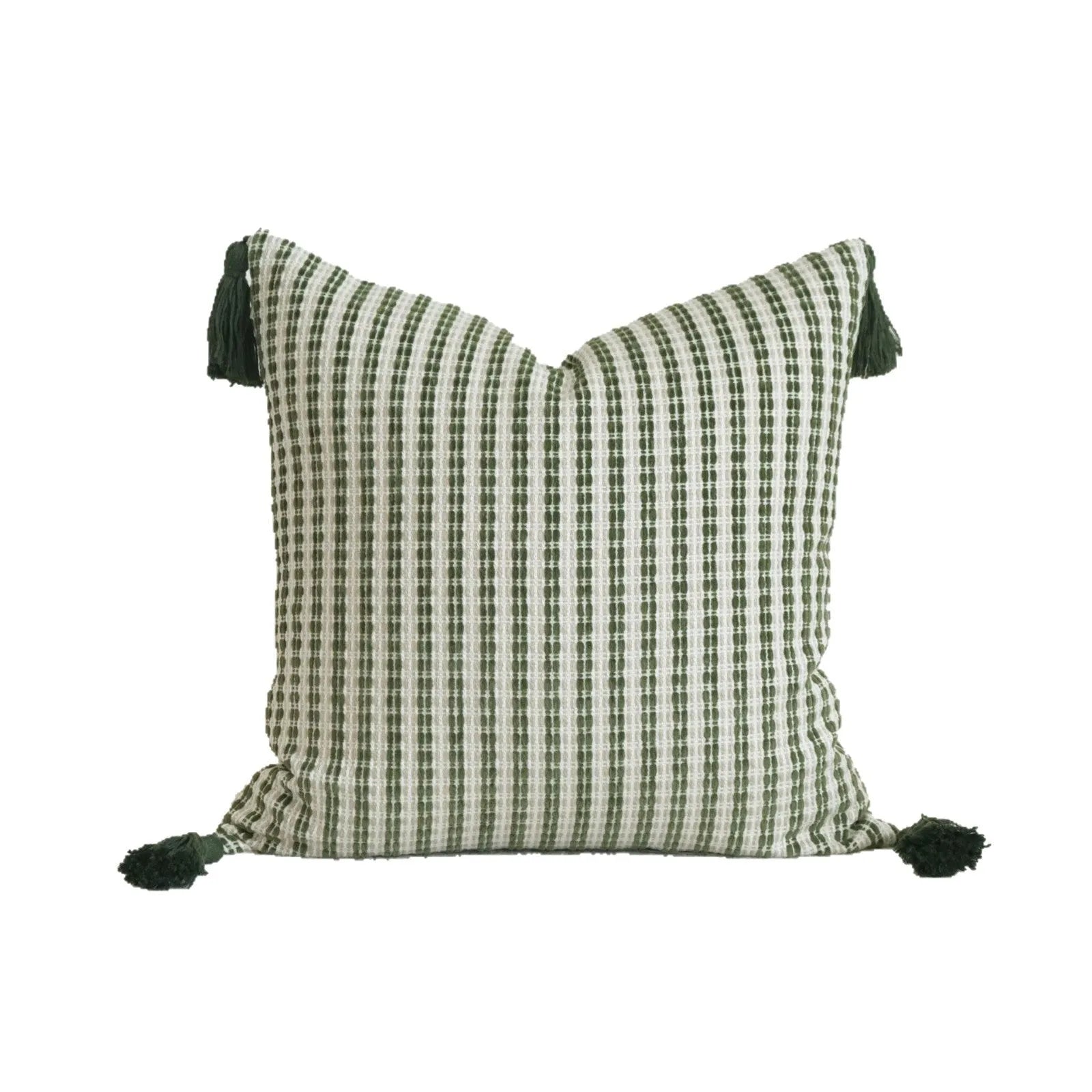 Green cotton and linen hotel sample pillow with botanical pattern and tassel detail on a display bed.