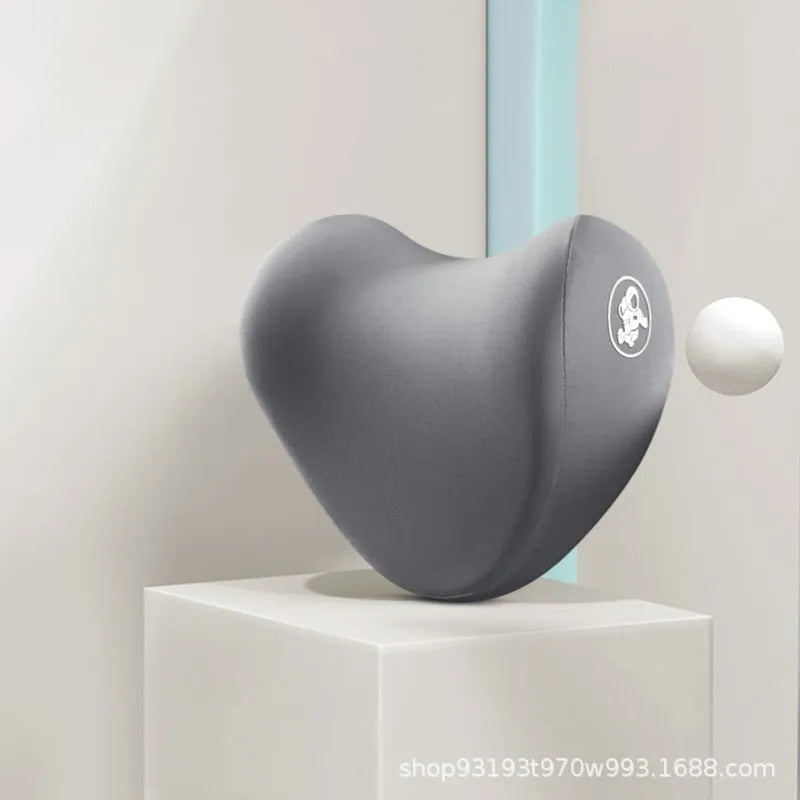 Heart-shaped car pillow in choice of colours, shown as headrest and lumbar support on a car seat.