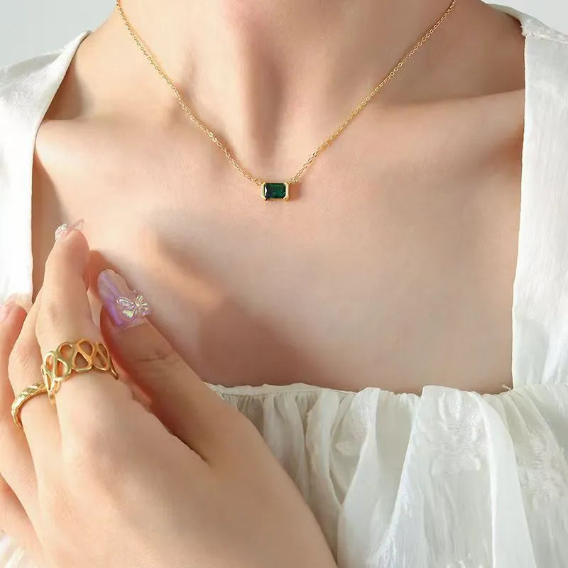 Women's gold geometric pendant necklace with quadrilateral design and inset cubic zirconia stones on chain