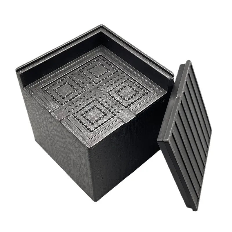 Black plastic furniture height adjustment mats in four-piece set for bed and sofa feet
