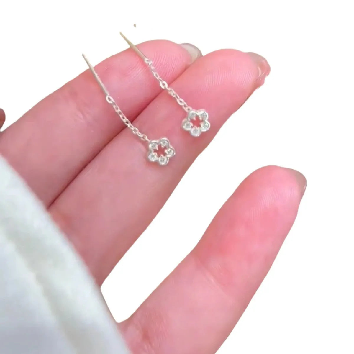 Sterling silver hollow flower drop earrings with needle posts and petal detailing
