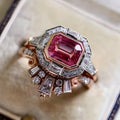 Rose gold alloy women's ring with a geometric design and ruby-coloured stone in a retro style.