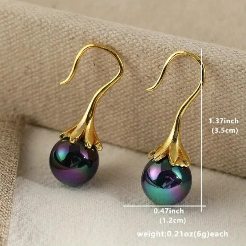 A pair of gold-coloured retro fashion earrings for women with an alloy construction.