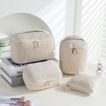 Four-piece set of cube-shaped flannelette makeup bags in a choice of colours.