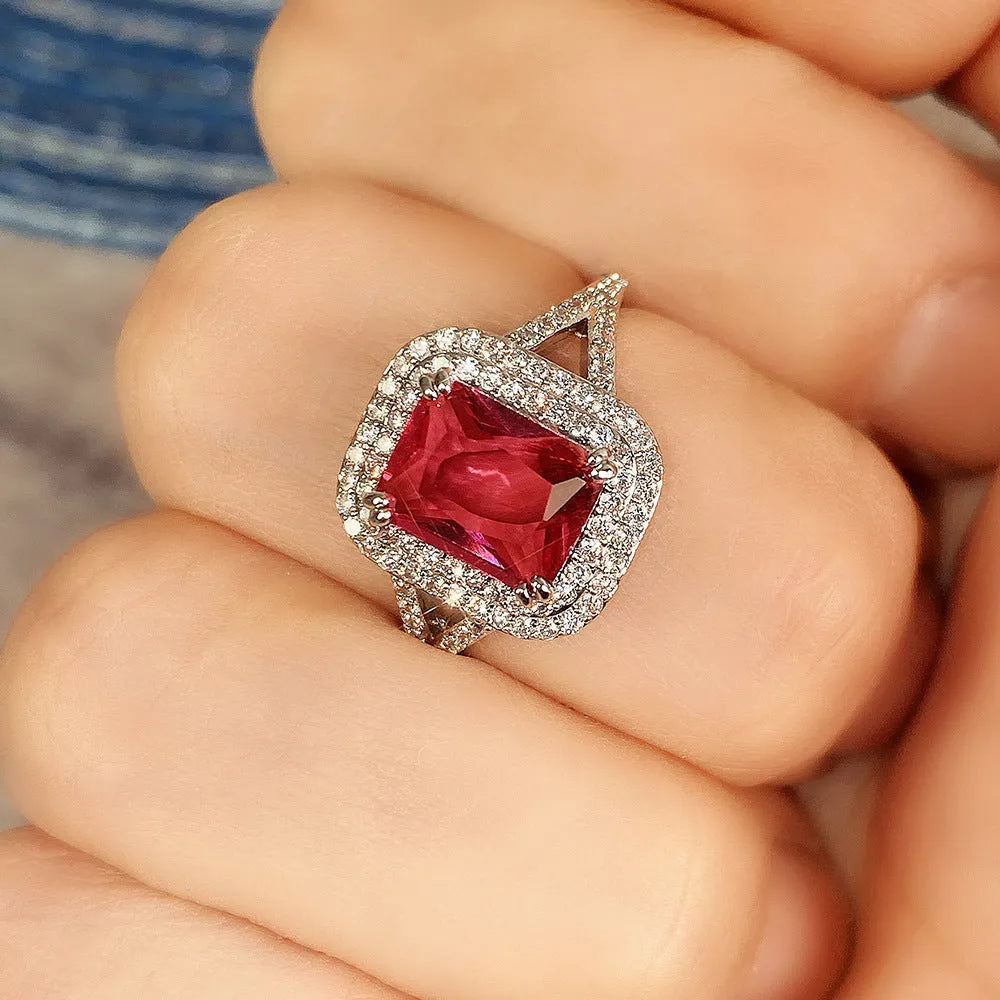 Women's square copper ring with a large red rhinestone set in a geometric princess style.