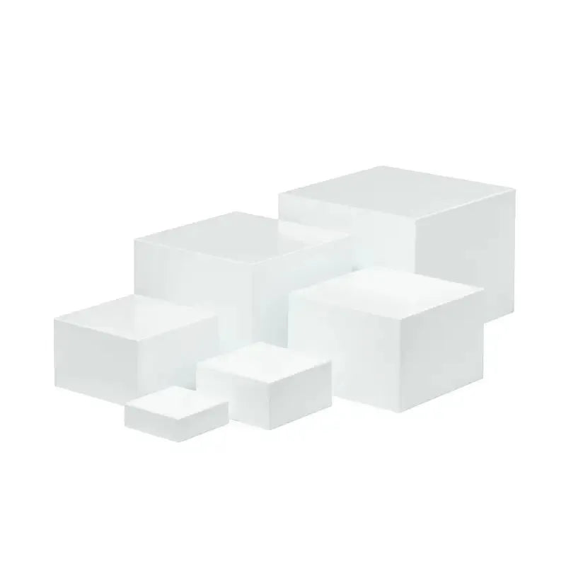 White plastic modular dessert display stand cubes stacked to form a tiered tabletop cake stand.