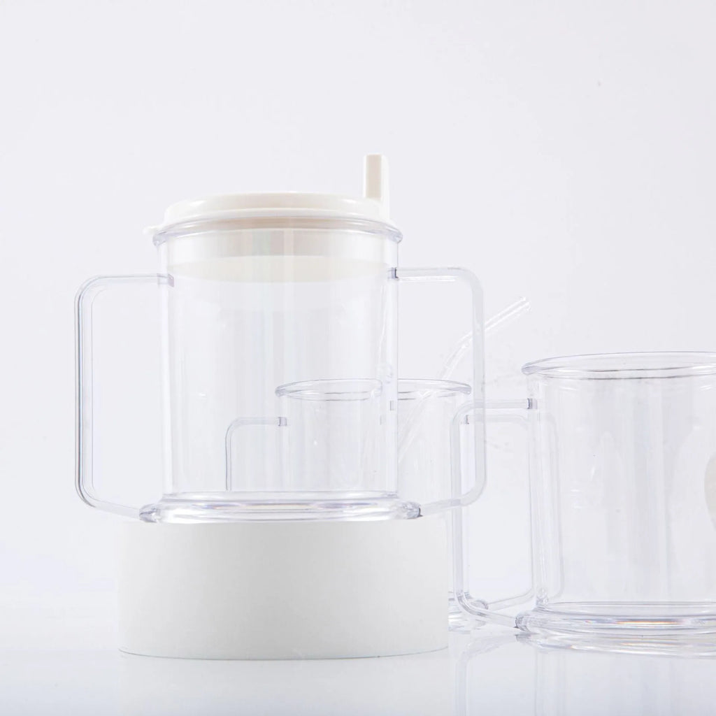 Transparent plastic drinking cup with spill-proof design on a plain background.