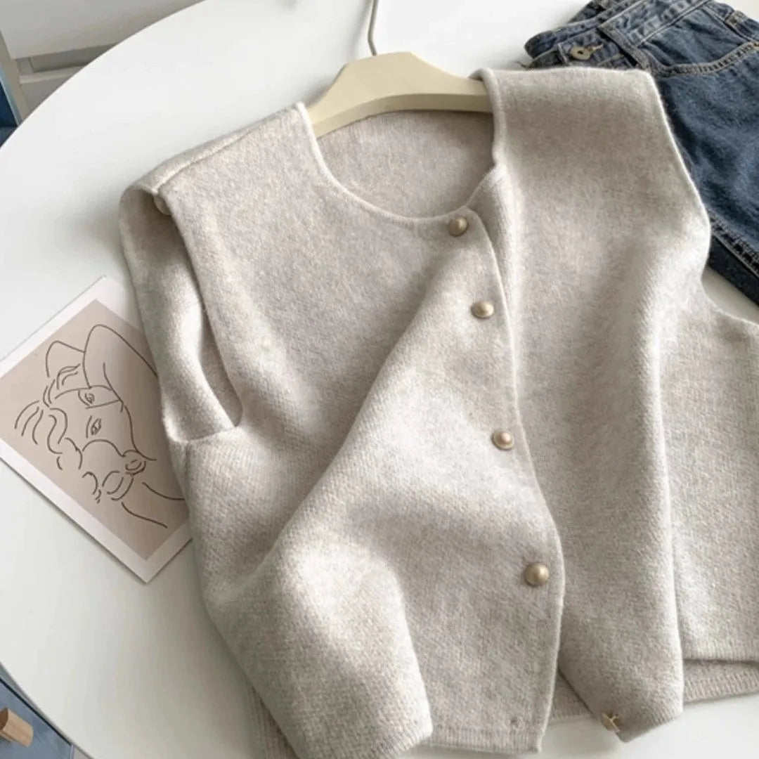Thin polyester pullover vest with half sleeves in various colours on a hanger