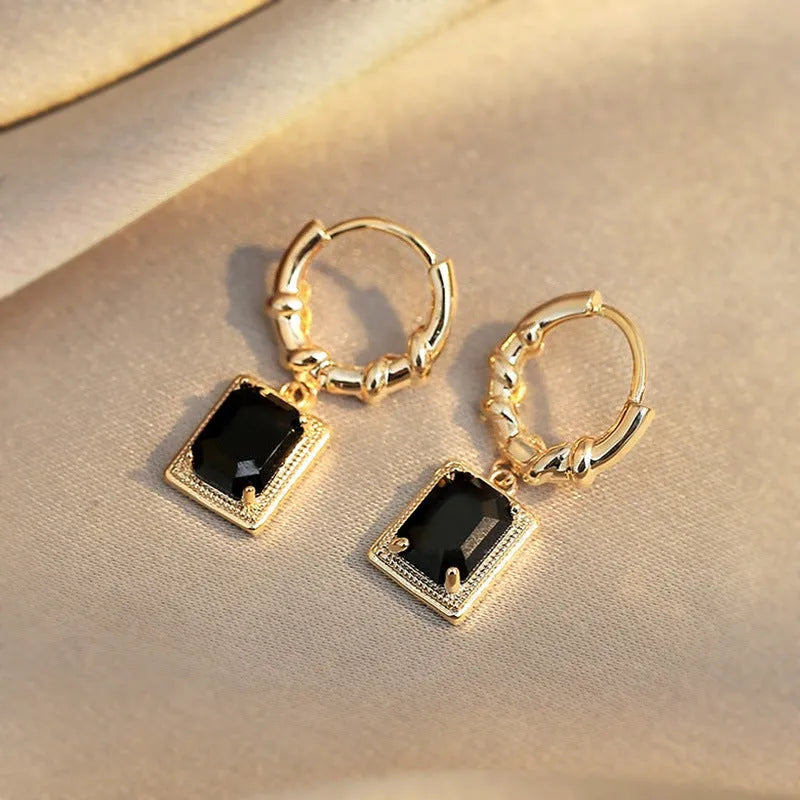 A pair of black geometric quadrilateral copper earrings with a retro French court design.