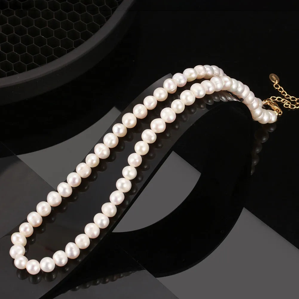Women's adjustable necklace with natural freshwater pearls on a sterling silver chain.
