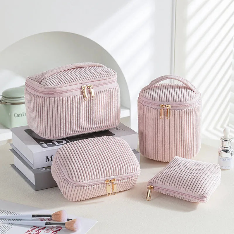 Four cube-shaped flannelette makeup bags in a set, shown in a blue with dots pattern.