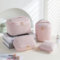 Four cube-shaped flannelette makeup bags in a set, shown in a blue with dots pattern.