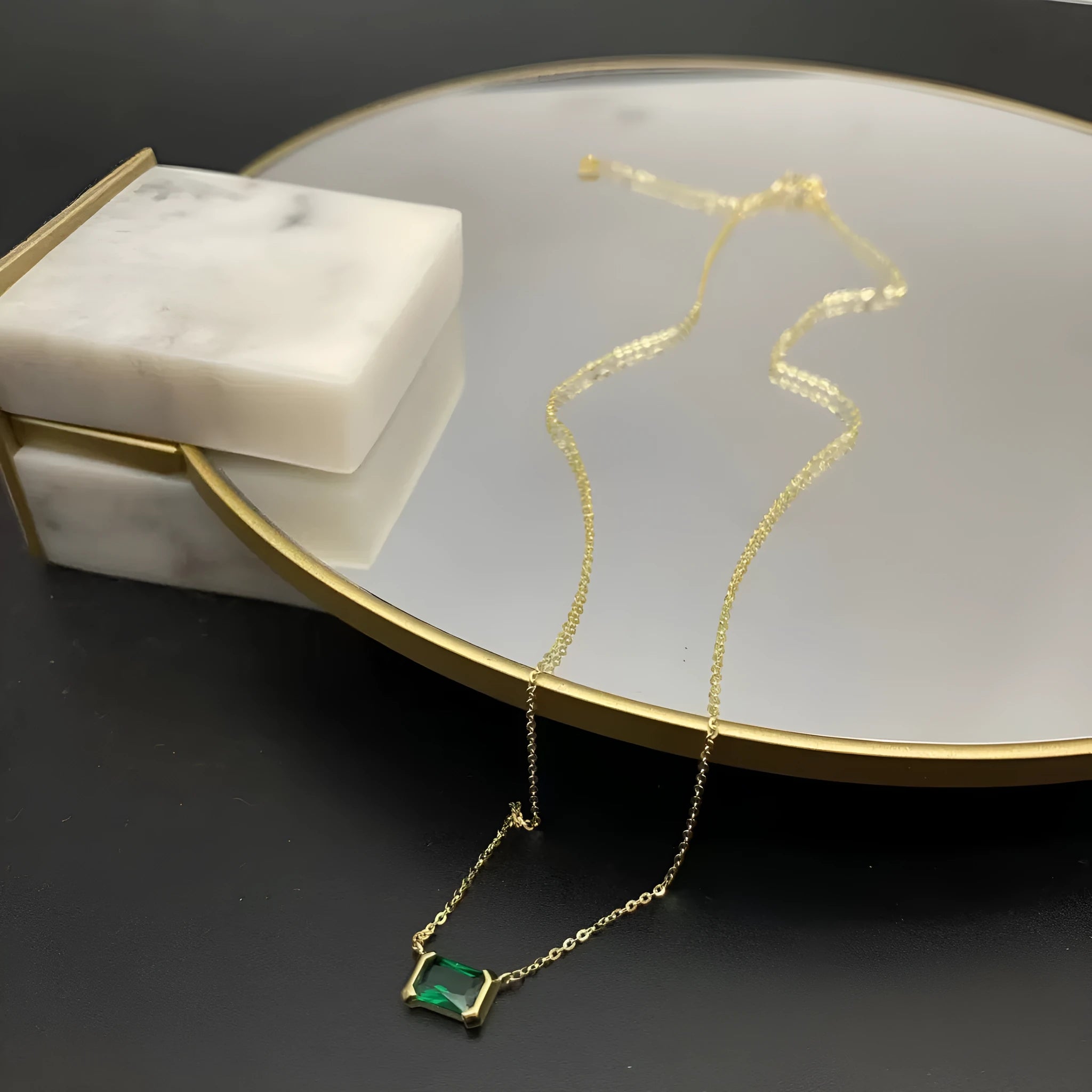Women's gold geometric pendant necklace with quadrilateral design and inset cubic zirconia stones on chain