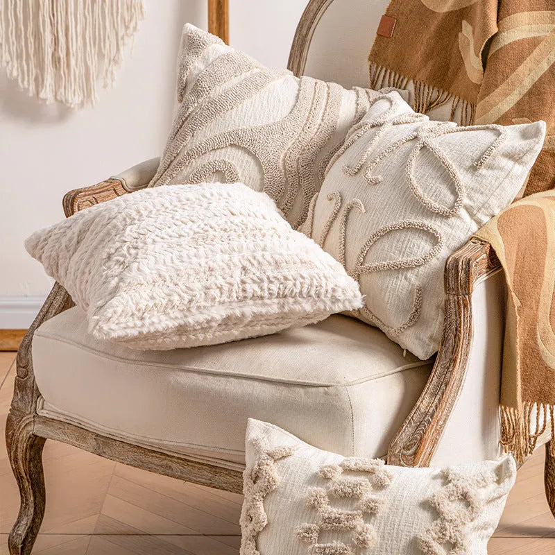 Knitted cushion cover with tassel trim in a choice of patterned designs including spiral dots and bow.