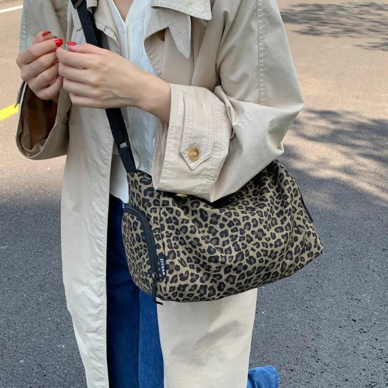 Leopard print sports style shoulder messenger bag with crossbody strap and striped lining