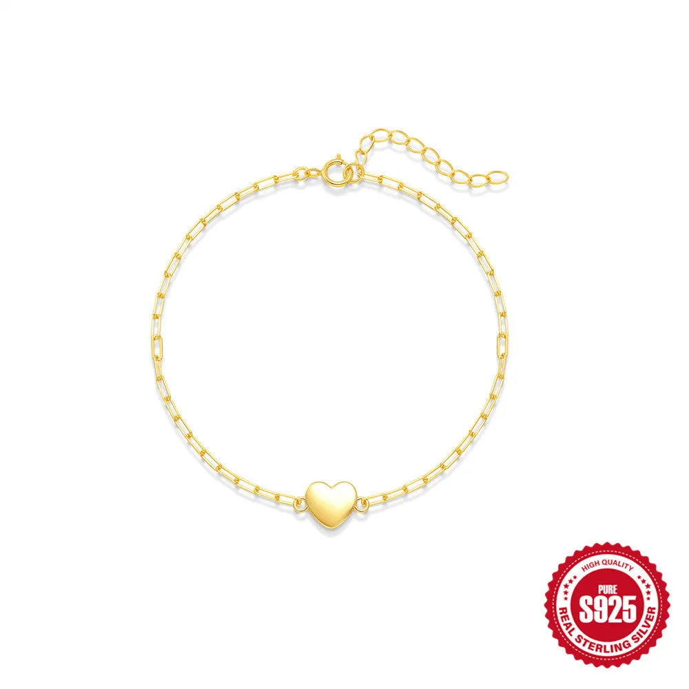 S925 sterling silver bracelet with clip chain fastening and glossy gold heart charm