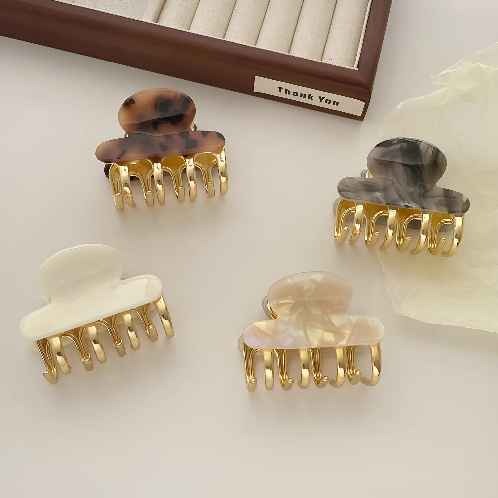 Medium metal grip women's barrette in retro acetate style, alloy acrylic construction, shown in one of four colour options.