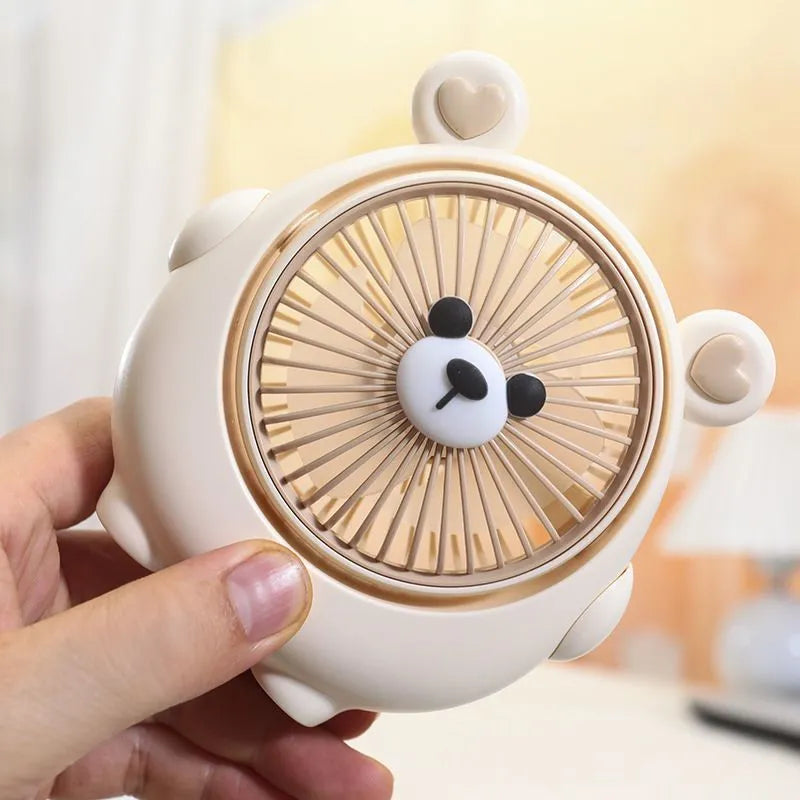 Cute dog-shaped desktop USB fan in a choice of colours on a wooden desk.