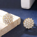Pair of copper electroplated stud earrings in silver with irregular and round shapes on white background